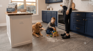 A modern kitchen featuring textured, slip resistant gray floor tiles handling a messy everyday scenario.